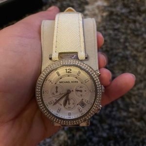 White leather band. Silver face.